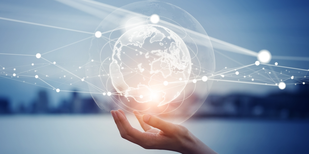 An arm holding a globe on a blue background